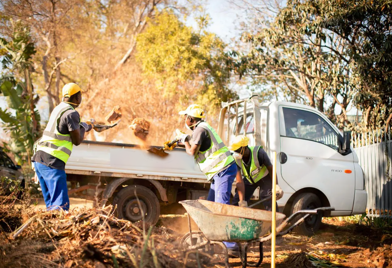 three-workers-clearing-site